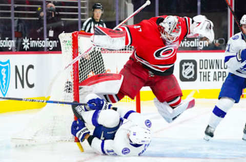 Feb 22, 2021; Raleigh, North Carolina, USA; Carolina Hurricanes goaltender James Reimer (47) jumps out of the way of Tampa Bay Lightning left wing Ondrej Palat (18) during the third period at PNC Arena. Mandatory Credit: James Guillory-USA TODAY Sports