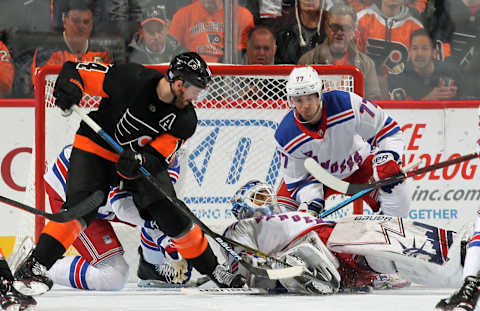 PHILADELPHIA, PA – NOVEMBER 23: Sean Couturier #14 of the Philadelphia Flyers battles for the puck under goaltender Henrik Lundqvist #30 of the New York Rangers with Tony DeAngelo #77 on November 23, 2018 at the Wells Fargo Center in Philadelphia, Pennsylvania. (Photo by Len Redkoles/NHLI via Getty Images)