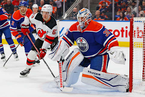 Dec 10, 2023; Edmonton, Alberta, CAN; New Jersey Devils forward Jesper Brett (63) looks for a rebound in front of Edmonton Oilers goaltender Calvin Pickard (30) during the second period at Rogers Place. Mandatory Credit: Perry Nelson-USA TODAY Sports