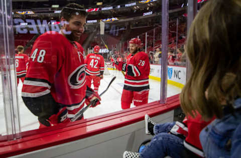 RALEIGH, NC – SEPTEMBER 27: Carolina Hurricanes left wing Jordan Martinook (48) checks in with his son Chase during warm ups just prior to an NHL Pre-Season game between the Carolina Hurricanes and the Nashville Predators on September 27, 2019 at the PNC Arena in Raleigh, NC. (Photo by John McCreary/Icon Sportswire via Getty Images)