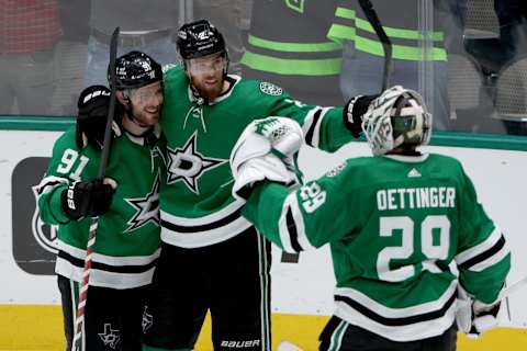 DALLAS, TEXAS – MARCH 22: Tyler Seguin #91 of the Dallas Stars celebrates with Jani Hakanpaa #2 of the Dallas Stars and Jake Oettinger #29 of the Dallas Stars after scoring an empty net goal against the Edmonton Oilers in the third period at American Airlines Center on March 22, 2022 in Dallas, Texas. (Photo by Tom Pennington/Getty Images)