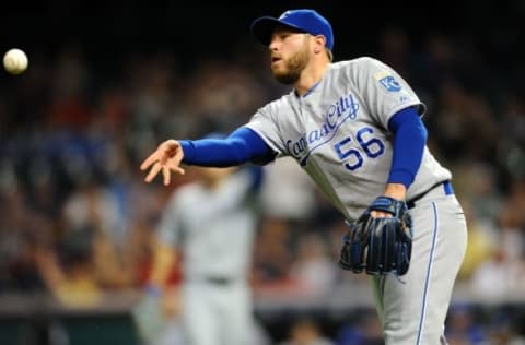 Sep 15, 2015; Cleveland, OH, USA; Kansas City Royals relief pitcher Greg Holland (56) flips the ball to third base to make a force out during the ninth inning against the Cleveland Indians at Progressive Field. The Royals won 2-0. Mandatory Credit: Ken Blaze-USA TODAY Sports