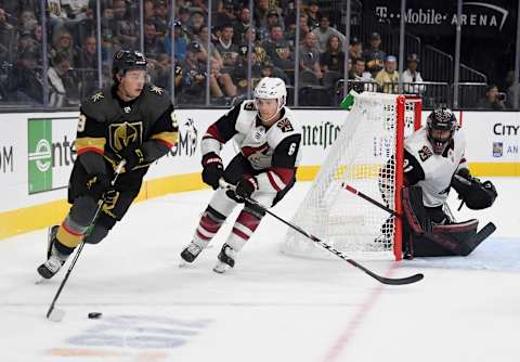 LAS VEGAS, NEVADA – SEPTEMBER 15: Cody Glass #9 of the Vegas Golden Knights skates with the puck against Jakob Chychrun #6 of the Arizona Coyotes as Adin Hill #31 of the Coyotes tends net in the second period of their preseason game at T-Mobile Arena on September 15, 2019 in Las Vegas, Nevada. The Golden Knights defeated the Coyotes 6-2. (Photo by Ethan Miller/Getty Images)