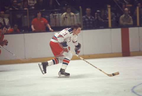 Canadian professional ice hockey player Pete Stemkowski #21 of the New York Rangers skates on the ice during a game at Madison Square Garden as opponent Guy Lapointe (left) of the Montreal Canadiens approaches at some distance, New York, 1970s. Stemkowski played for the Rangers from 1971 to 1977. (Photo by Melchior DiGiacomo/Getty Images)