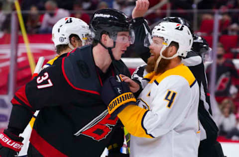 May 17, 2021; Raleigh, North Carolina, USA; Carolina Hurricanes right wing Andrei Svechnikov (37) and Nashville Predators defenseman Ryan Ellis (4) have word during the third period in game one of the first round of the 2021 Stanley Cup Playoffs at PNC Arena. Mandatory Credit: James Guillory-USA TODAY Sports