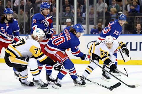 Apr 7, 2022; New York, New York, USA; New York Rangers left wing Artemi Panarin (10) fights for the puck against Pittsburgh Penguins center Jeff Carter (77) and center Teddy Blueger (53) during the first period at Madison Square Garden. Mandatory Credit: Brad Penner-USA TODAY Sports