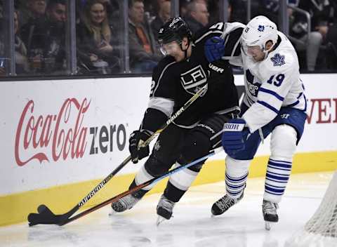 Jan 7, 2016; Los Angeles, CA, USA; Los Angeles Kings defenseman Luke Schenn (left) and Toronto Maple Leafs left wing Joffrey Lupul (19) battle for the puck during the third period at Staples Center. The Los Angeles Kings won 2-1. Mandatory Credit: Kelvin Kuo-USA TODAY Sports