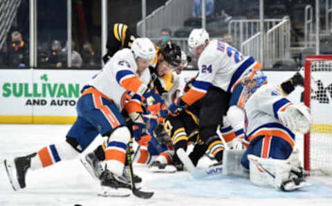 May 10, 2021; Boston, Massachusetts, USA; New York Islanders center Casey Cizikas (53) and Boston Bruins left wing Taylor Hall (71) battle for a loose puck in front of goaltender Semyon Varlamov (40) during the second period at TD Garden. Mandatory Credit: Bob DeChiara-USA TODAY Sports