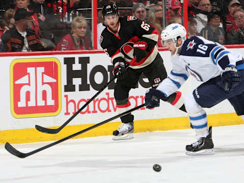 OTTAWA, CANADA – FEBRUARY 9: Erik Karlsson #65 of the Ottawa Senators passes the puck through Andrew Ladd #16 of the Winnipeg Jets during an NHL game at Scotiabank Place on February 9, 2013 in Ottawa, Ontario, Canada. (Photo by Francois Laplante/Freestyle Photo/Getty Images)