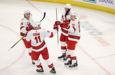 Feb 2, 2021; Chicago, Illinois, USA; Carolina Hurricanes left wing Warren Foegele (13) celebrates with teammates after scoring against the Chicago Blackhawks during the first period at United Center. Mandatory Credit: Kamil Krzaczynski-USA TODAY Sports