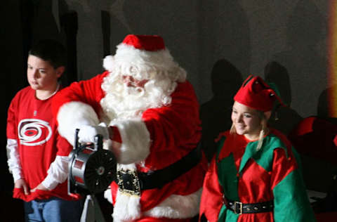 RALEIGH, NC – DECEMBER 23: Santa Claus sounds the Hurricane warning siren prior to a NHL game between the Carolina Hurricanes and the Montreal Canadiens on December 23, 2009 at RBC Center in Raleigh, North Carolina. (Photo by Gregg Forwerck/NHLI via Getty Images)