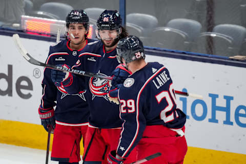 Oct 2, 2023; Columbus, Ohio, USA; Columbus Blue Jackets left wing Kirill Marchenko, middle, celebrates with teammates left wing Johnny Gaudreau (13) and right wing Patrik Laine (29) after scoring a goal against the St. Louis Blues in the first period at Nationwide Arena. Mandatory Credit: Aaron Doster-USA TODAY Sports