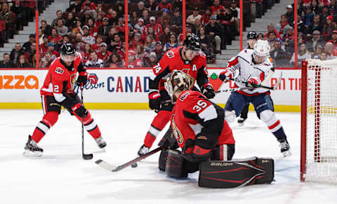 OTTAWA, ON – JANUARY 31: Marcus Hogberg #35 of the Ottawa Senators makes a save as teammates Dylan DeMelo #2 and Mark Borowiecki #74 defend against Brendan Leipsic #28 of the Washington Capitals at Canadian Tire Centre on January 31, 2020 in Ottawa, Ontario, Canada. (Photo by Jana Chytilova/Freestyle Photography/Getty Images)