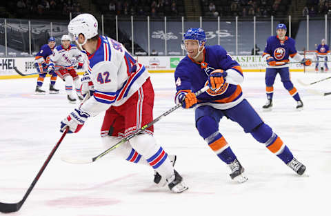 : Travis Zajac #14 of the New York Islanders checks Brendan Smith #42 of the New York Rangers . (Photo by Bruce Bennett/Getty Images)