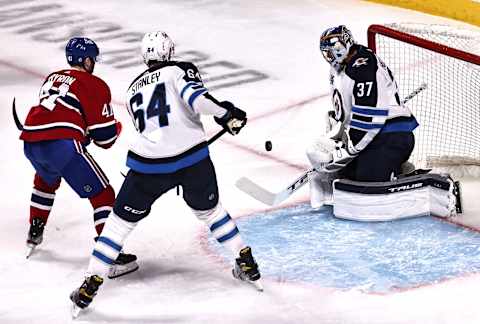 Winnipeg Jets, Connor Hellebuyck (37), Logan Stanley (64); Montreal Canadiens, Paul Byron (41) Mandatory Credit: Jean-Yves Ahern-USA TODAY Sports