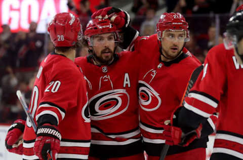 RALEIGH, NC – APRIL 4: Sebastian Aho #20 and Nino Niederreiter #21 celebrate a goal by teammate Justin Faulk, center, of the Carolina Hurricanes against the New Jersey Devils during an NHL game at PNC Arena on April 4, 2019, in Raleigh, North Carolina. (Photo by Gregg Forwerck/NHLI via Getty Images)