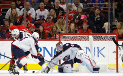 RALEIGH, NORTH CAROLINA – OCTOBER 12: Daniil Tarasov #40 of the Columbus Blue Jackets makes a save against Seth Jarvis #24 of the Carolina Hurricanes during the third period of the game at PNC Arena on October 12, 2022 in Raleigh, North Carolina. (Photo by Jared C. Tilton/Getty Images)