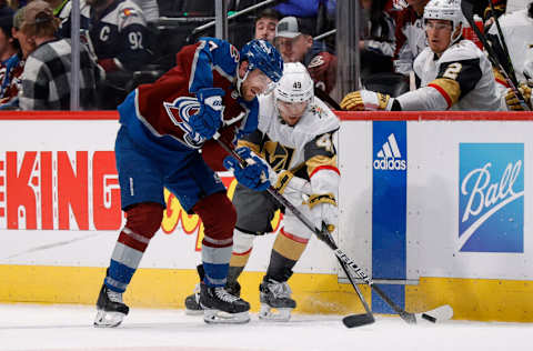 Feb 27, 2023; Denver, Colorado, USA; Colorado Avalanche defenseman Devon Toews (7) and Vegas Golden Knights center Ivan Barbashev (49) battle for the puck in the third period at Ball Arena. Mandatory Credit: Isaiah J. Downing-USA TODAY Sports