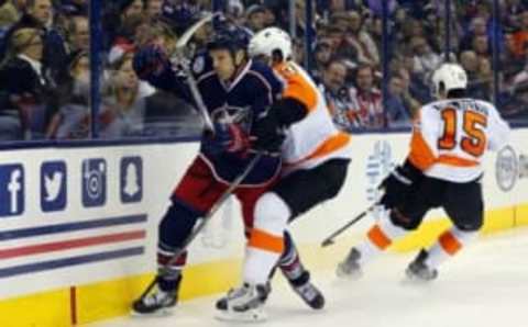 Dec 19, 2015; Columbus, OH, USA; Philadelphia Flyers defenseman Radko Gudas (3) and Columbus Blue Jackets right wing David Clarkson (23) battle for the loose puck during the second period at Nationwide Arena. Mandatory Credit: Russell LaBounty-USA TODAY Sports