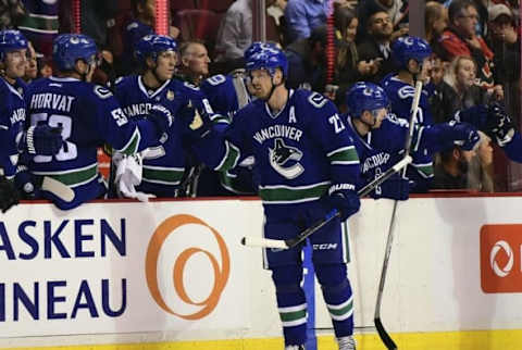 Oct 6, 2016; Vancouver, British Columbia, CAN; Vancouver Canucks forward Daniel Sedin (22) celebrates his goal during the second period during a preseason hockey game at Rogers Arena. Mandatory Credit: Anne-Marie Sorvin-USA TODAY Sports