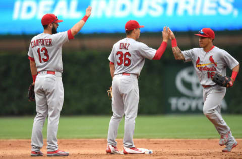 Jun 22, 2016; Chicago, IL, USA; St. Louis Cardinals center fielder Kolten Wong (right) celebrates with shortstop Aledmys Diaz (center) and second baseman Matt Carpenter (left) after their victory over the Chicago Cubs at Wrigley Field. Cardinals won 7-2. Mandatory Credit: Patrick Gorski-USA TODAY Sports