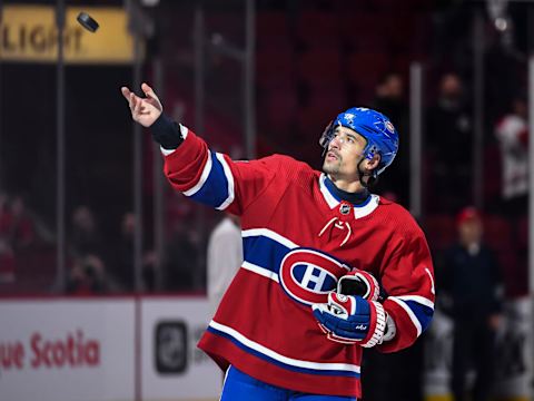 MONTREAL, QC – OCTOBER 15: Tomas Plekanec #14 of the Montreal Canadiens throws a puck towards the fans after playing in his 1000th career NHL game against the Detroit Red Wings at the Bell Centre on October 15, 2018 in Montreal, Quebec, Canada. The Montreal Canadiens defeated the Detroit Red Wings 7-3. (Photo by Minas Panagiotakis/Getty Images)