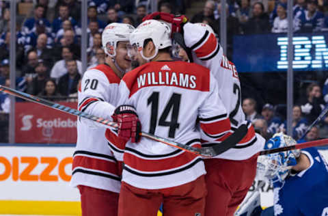 TORONTO, ON – APRIL 02: Carolina Hurricanes Right Wing Justin Williams (14) celebrates his goal with Center Sebastian Aho (20) and Left Wing Nino Niederreiter (21) during the first period of the NHL regular season game between the Carolina Hurricanes and the Toronto Maple Leafs on April 2, 2019, at Scotiabank Arena in Toronto, ON, Canada. (Photo by Julian Avram/Icon Sportswire via Getty Images)