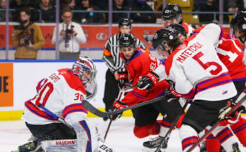 KITCHENER, ONTARIO – MARCH 23: Luca Del Bel Belluz #73 of Team Red battles for the puck with Mason Beaupit #30 of Team White and Denton Mateychuk #5 in the 2022 CHL/NHL Top Prospects Game at Kitchener Memorial Auditorium on March 23, 2022 in Kitchener, Ontario. (Photo by Chris Tanouye/Getty Images)