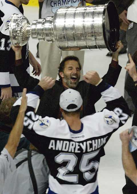 TAMPA, FL – JUNE 7: Coach John Tortorella of the Tampa Bay Lightning holds the Stanley Cup over his head while celebrating victory over the Calgary Flames with Dave Andreychuk