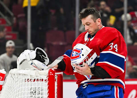 Oct 21, 2023; Montreal, Quebec, CAN; Montreal Canadiens goalie Jake Allen (34) looks at his helmet before putting it on his head against the Washington Capitals during the first period at Bell Centre. Mandatory Credit: David Kirouac-USA TODAY Sports