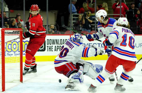 RALEIGH, NC – NOVEMBER 7: Henrik Lundqvist #30 of the New York Rangers attempts to make a save in the crease as Jordan Staal #11 of the Carolina Hurricanes keeps his eye on the puck looking for a rebound opportunity during an NHL game on November 7, 2019 at PNC Arena in Raleigh, North Carolina. (Photo by Gregg Forwerck/NHLI via Getty Images)