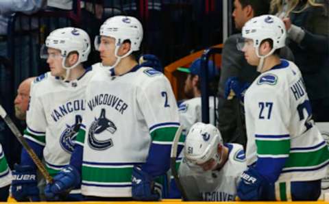 NASHVILLE, TENNESSEE – APRIL 04: Troy Stecher #51 of the Vancouver Canucks hangs his head at the bench after deflecting a puck into his own net giving the Nashville Predators a 3-2 victory at Bridgestone Arena on April 04, 2019 in Nashville, Tennessee. (Photo by Frederick Breedon/Getty Images)