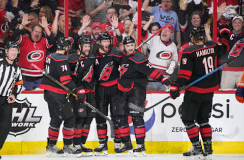 RALEIGH, NC – MAY 03: Carolina Hurricanes center Jordan Staal (11), Carolina Hurricanes right wing Nino Niederreiter (21) Carolina Hurricanes defenseman Jaccob Slavin (74), and Carolina Hurricanes defenseman Dougie Hamilton (19) congratulate Carolina Hurricanes right wing Justin Williams (14) after scoring his 100th playoff point during a game between the Carolina Hurricanes and the New York Islanders on March 3, 2019 at the PNC Arena in Raleigh, NC. (Photo by Greg Thompson/Icon Sportswire via Getty Images)