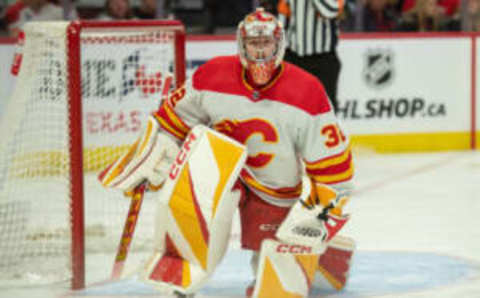 Nov 11, 2023; Ottawa, Ontario, CAN; Calgary Flames goalie Dustin Wolf (32) makes a save in the first period against the Ottawa Senators at the Canadian Tire Centre. Mandatory Credit: Marc DesRosiers-USA TODAY Sports