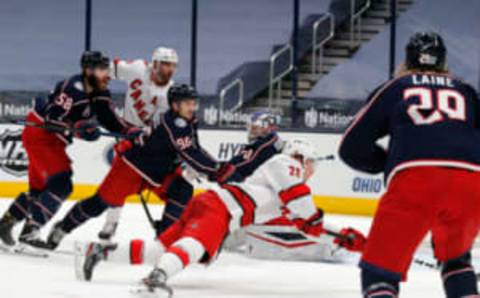 Feb 8, 2021; Columbus, Ohio, USA; Carolina Hurricanes left wing Brock McGinn (23) falls to the ice as he scores a goal against the Columbus Blue Jackets during the second period at Nationwide Arena. Mandatory Credit: Russell LaBounty-USA TODAY Sports