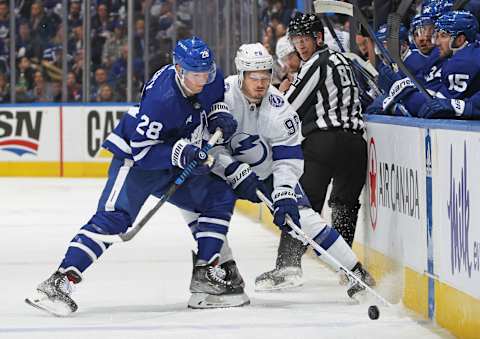 Mikhail Sergachev #98 of the Tampa Bay Lightning battles for the puck against Sam Lafferty #28 of the Toronto Maple Leafs   (Photo by Claus Andersen/Getty Images)