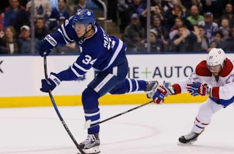 Feb 25, 2017; Toronto, Ontario, CAN; Toronto Maple Leafs forward Auston Matthews (34) shoots the puck as Montreal Canadiens forward Alex Galchenyuk (27) chases at the Air Canada Centre. Montreal defeated Toronto 3-2 in overtime. Mandatory Credit: John E. Sokolowski-USA TODAY Sports