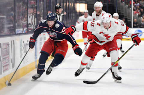 COLUMBUS, OH – JANUARY 16: Eric Robinson #50 of the Columbus Blue Jackets shields the puck from Brett Pesce #22 of the Carolina Hurricanes during the third period of a game on January 16, 2020 at Nationwide Arena in Columbus, Ohio. (Photo by Jamie Sabau/NHLI via Getty Images)