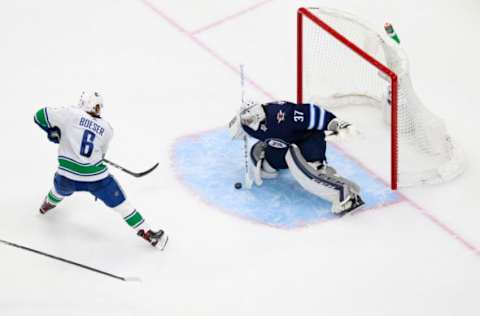 Winnipeg Jets, Connor Hellebuyck (37), Vancouver Canucks, Brock Boeser (6). (Photo by Jeff Vinnick/Getty Images)