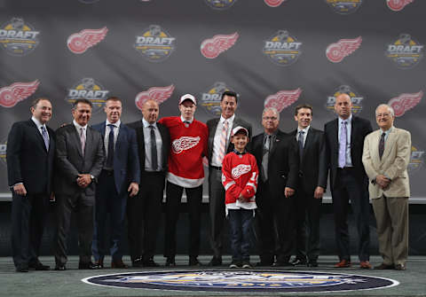 BUFFALO, NY – JUNE 24: Dennis Cholowski, selected 20th overall by the Detroit Red Wings, poses for a photo with the Detroit Red Wings team personnel during round one of the 2016 NHL Draft at First Niagara Center on June 24, 2016 in Buffalo, New York. (Photo by Dave Sandford/NHLI via Getty Images)