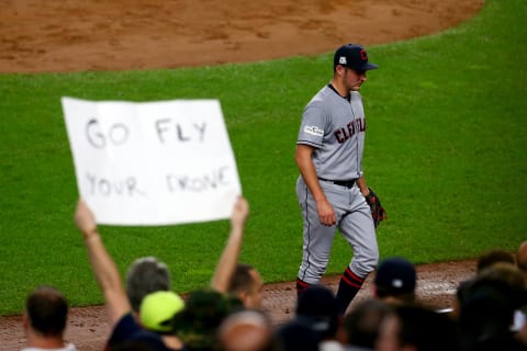 NEW YORK, NY – OCTOBER 09: Trevor Bauer #47 of the Cleveland Indians walks back to the dugout as a fan holds a sign that reads, “GO FLY YOUR DRONE” after being relieved during the second inning against the New York Yankees in Game Four of the American League Divisional Series at Yankee Stadium on October 9, 2017 in the Bronx borough of New York City. (Photo by Mike Stobe/Getty Images)