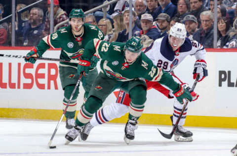 WINNIPEG, MB – FEBRUARY 26: Kevin Fiala #22 of the Minnesota Wild plays the puck down the ice as Patrik Laine #29 of the Winnipeg Jets gives chase during first period action at the Bell MTS Place on February 26, 2019 in Winnipeg, Manitoba, Canada. (Photo by Jonathan Kozub/NHLI via Getty Images)