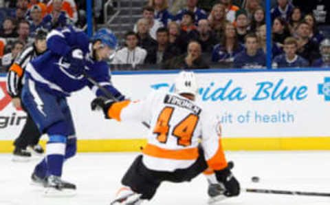 Nov 27, 2013; Tampa, FL, USA; Tampa Bay Lightning defenseman Victor Hedman (77) shoots as Philadelphia Flyers defenseman Kimmo Timonen (44) defends during the second period at Tampa Bay Times Forum. Mandatory Credit: Kim Klement-USA TODAY Sports