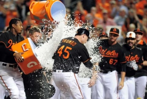 Sep 23, 2016; Baltimore, MD, USA; Baltimore Orioles outfielder Mark Trumbo (45) is congratulated by teammates after hitting the game winning home run to beat the Arizona Diamondbacks 3-2 at Oriole Park at Camden Yards. Mandatory Credit: Evan Habeeb-USA TODAY Sports