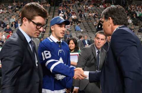 DALLAS, TX – JUNE 23: Sean Durzi greets his team after being selected 52nd overall by the Toronto Maple Leafs during the 2018 NHL Draft at American Airlines Center on June 23, 2018 in Dallas, Texas. (Photo by Brian Babineau/NHLI via Getty Images)