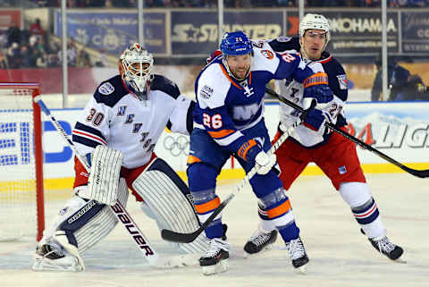 Jan 29, 2014; New York City, NY, USA; New York Islanders left wing Thomas Vanek (26) battles for position between New York Rangers goalie Henrik Lundqvist (30) and defenseman Ryan McDonagh (27) in the first period during the Stadium Series hockey game at Yankee Stadium. Mandatory Credit: Ed Mulholland-USA TODAY Sports