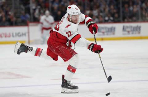 Brett Pesce, Carolina Hurricanes shooting the puck against the Colorado Avalanche (Photo by Matthew Stockman/Getty Images)