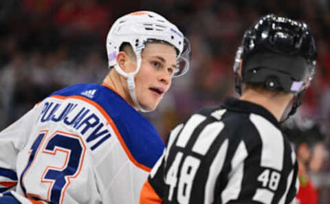 Nov 30, 2022; Chicago, Illinois, USA; Edmonton Oilers forward Jesse Puljujarvi (13) talks with referee Beau Halkidis (48) during the second period of a game against the Chicago Blackhawks at United Center. Mandatory Credit: Jamie Sabau-USA TODAY Sports