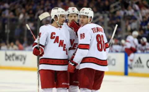 May 22, 2022; New York, New York, USA; Carolina Hurricanes center Seth Jarvis (24) talks with center Sebastian Aho (20) and left wing Teuvo Teravainen (86) during the third period against the New York Rangers in game three of the second round of the 2022 Stanley Cup Playoffs at Madison Square Garden. Mandatory Credit: Danny Wild-USA TODAY Sports