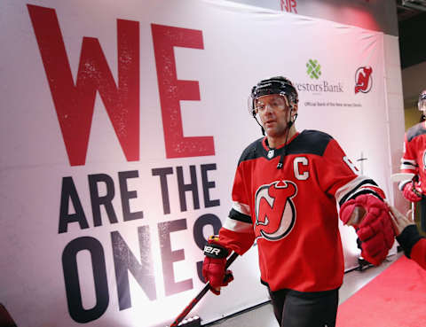 Andy Greene leads the New Jersey Devils onto the ice in 2019. (Photo by Bruce Bennett/Getty Images)